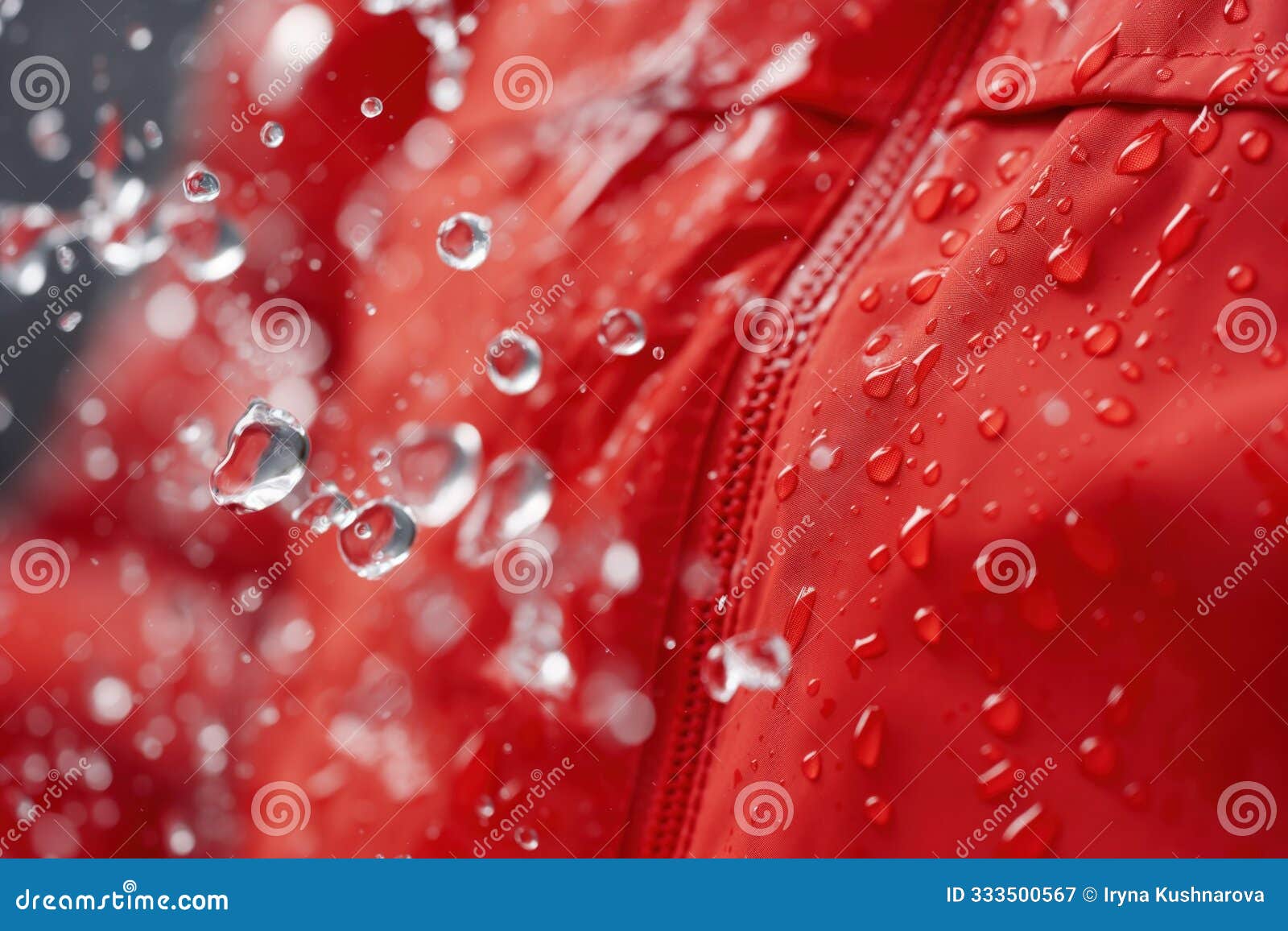 wet red jacket with white raindrops on waterproof synthetic ripstop fabric. close-up studio photography of water-repellent