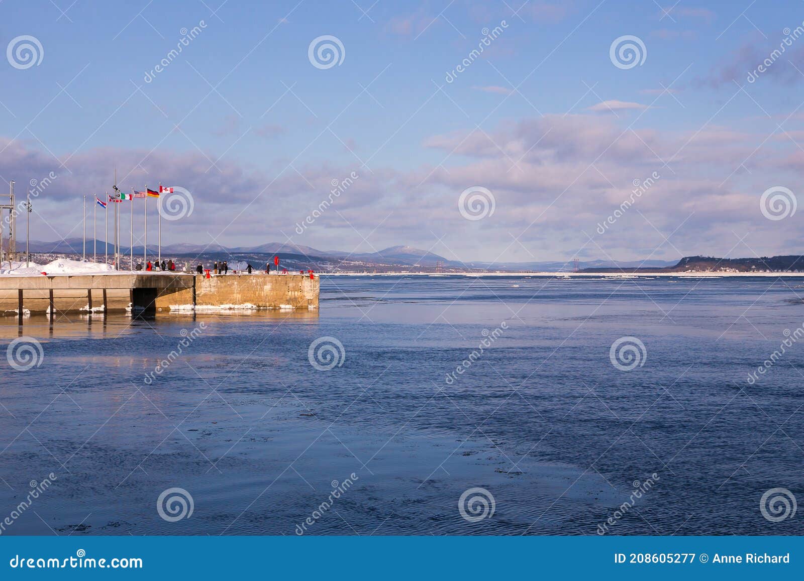 wharf in the old town harbour sector, with the island of orleans and the north shore in the background, quebec city