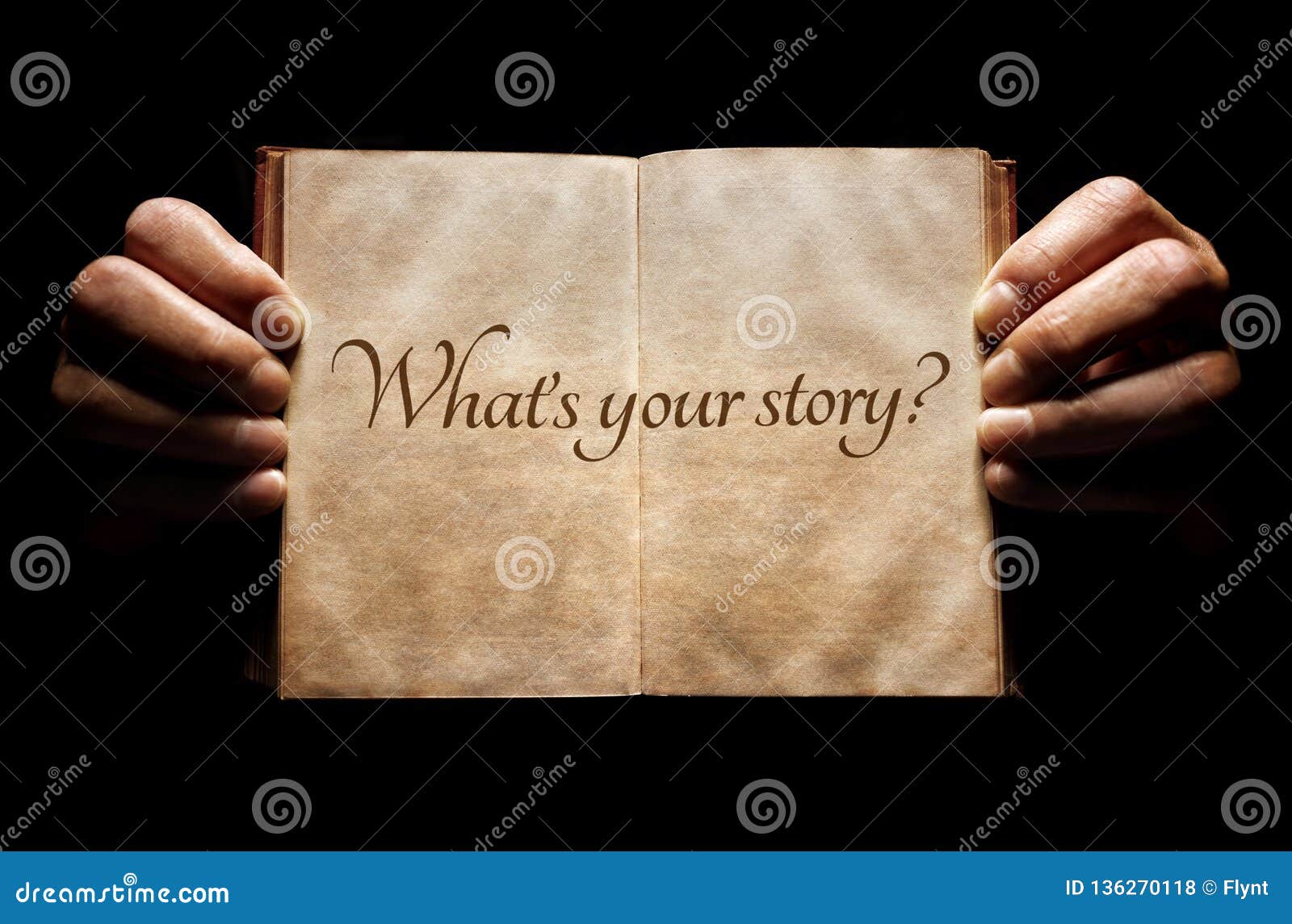 what`s your story? hands holding an open book background