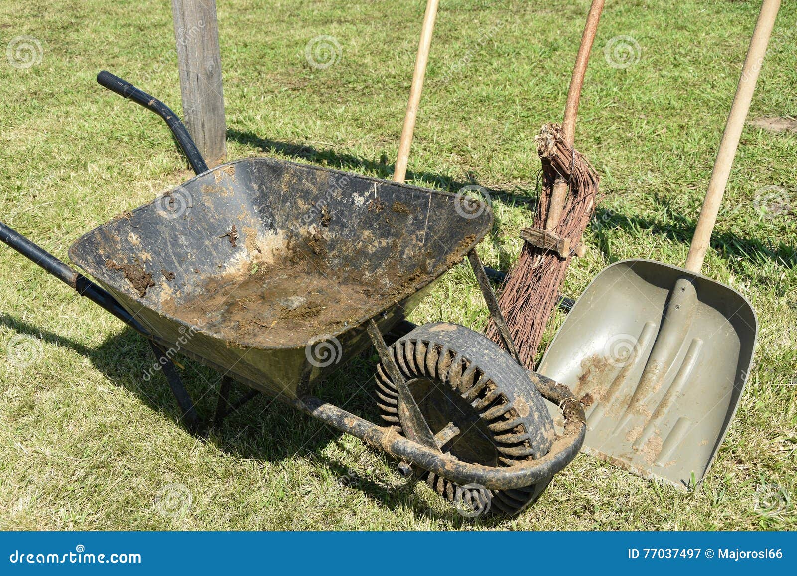 Wheelbarrow and shovel stock image. Image of broom, grass 77037497