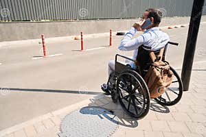 Wheelchair bound Person Talking On Cellular Phone Outside Stock Photo Wheelchair bound Person Talking On Cellular Phone Outside Stock Photo