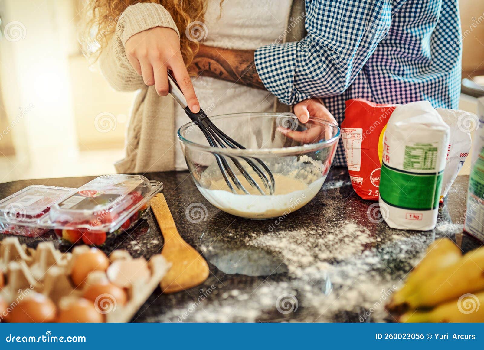 Whisk Me Off My Feet. an Unrecognizable Couple Baking in the Kitchen