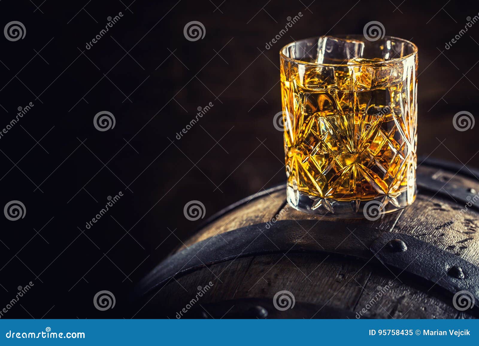 whiskey drink. glass of whiskey on old wooden barrel