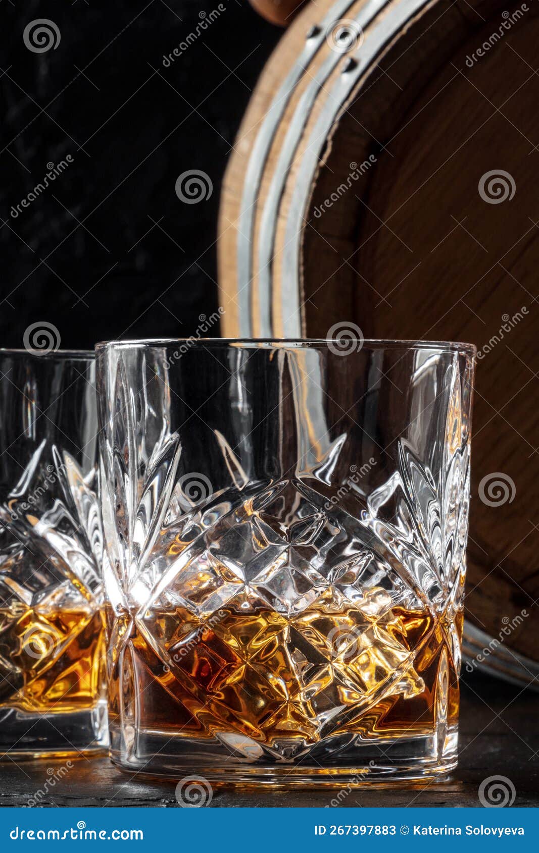 whiskey in a glass with a barrel. bourbon whisky and a cask on a dark background
