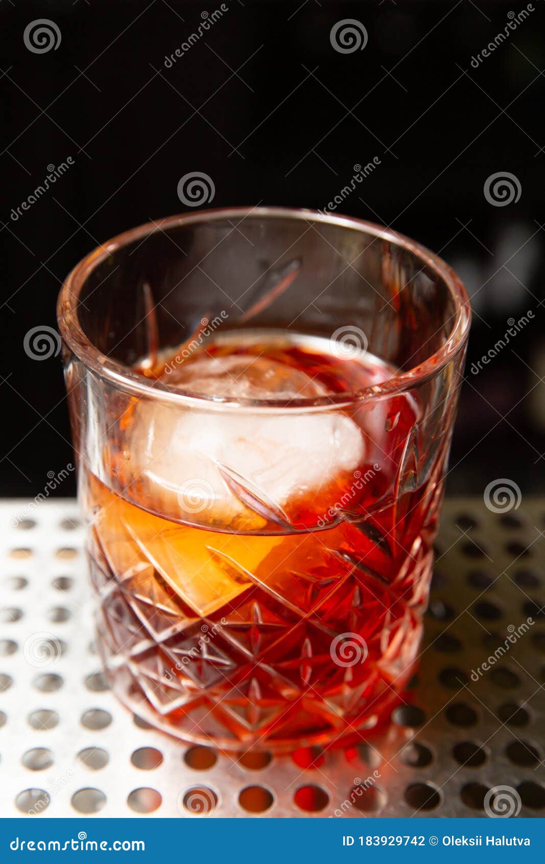 Whiskey with an Ice Ball in a Glass Stock Photo - Image of brandy