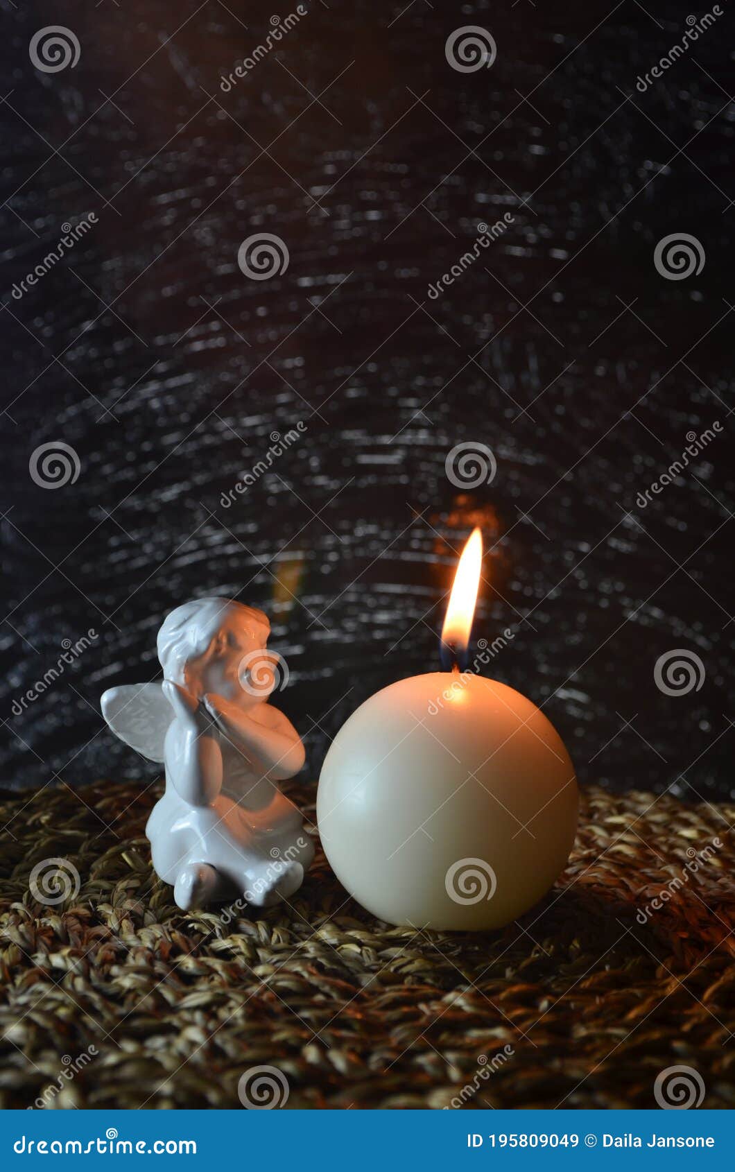 White Angel and White Burning Candle on Dark Background Stock Image
