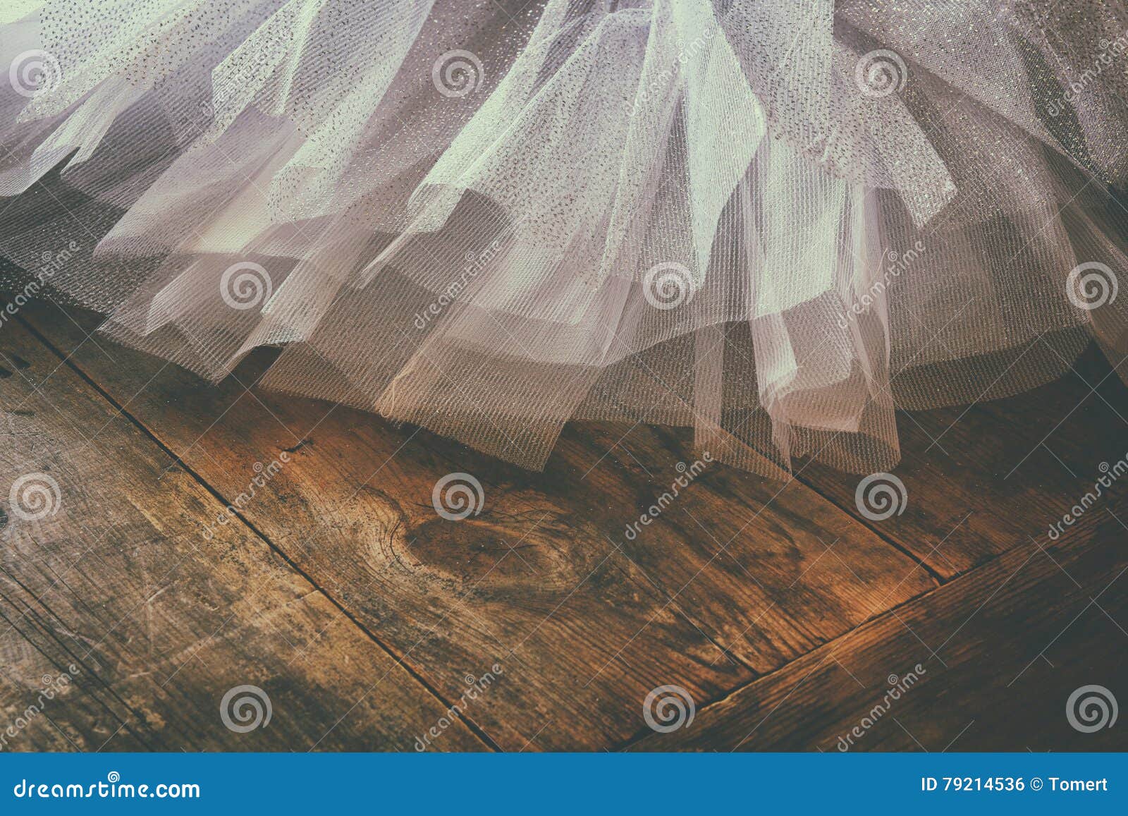 white ballet tutu on wooden floor. retro filtered