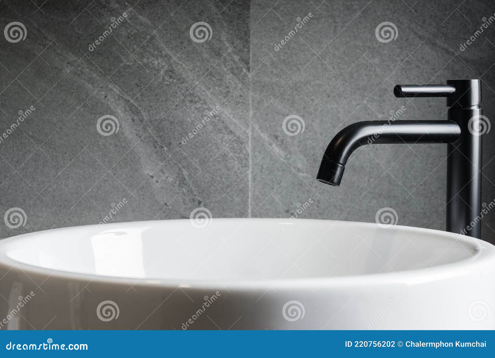 bathroom sink with black faucet