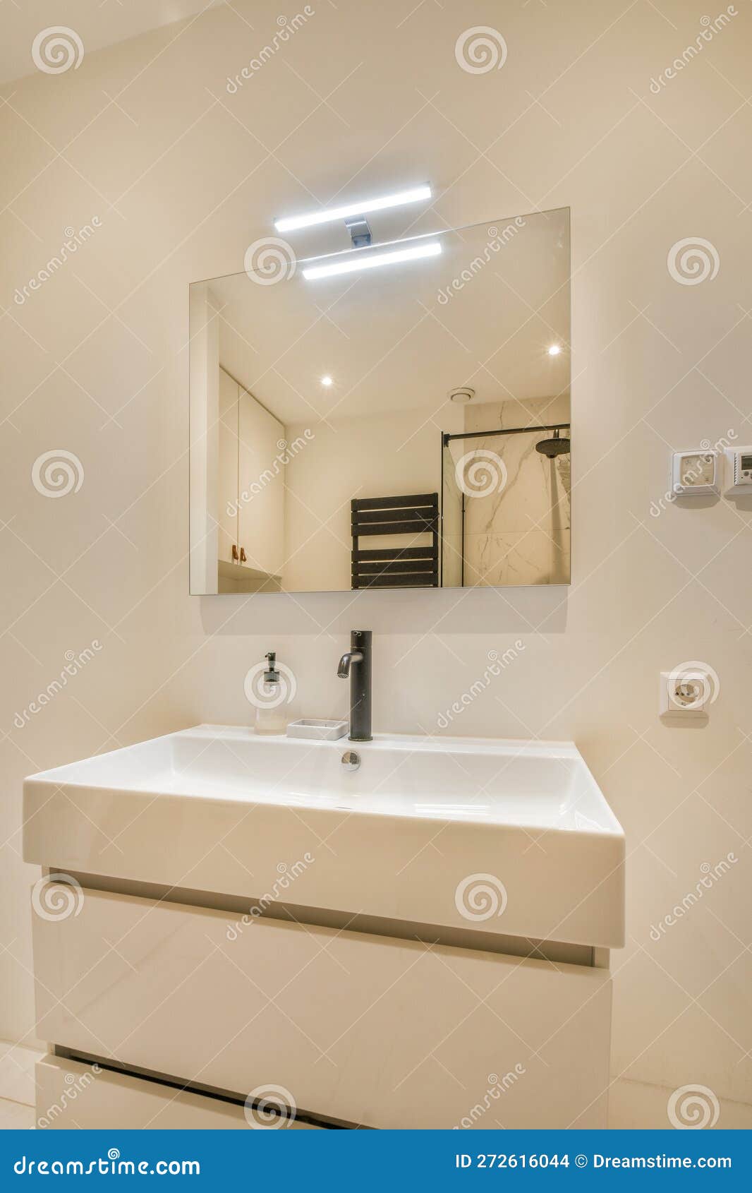 A White Bathroom with a Sink and a Mirror Stock Photo Image of house