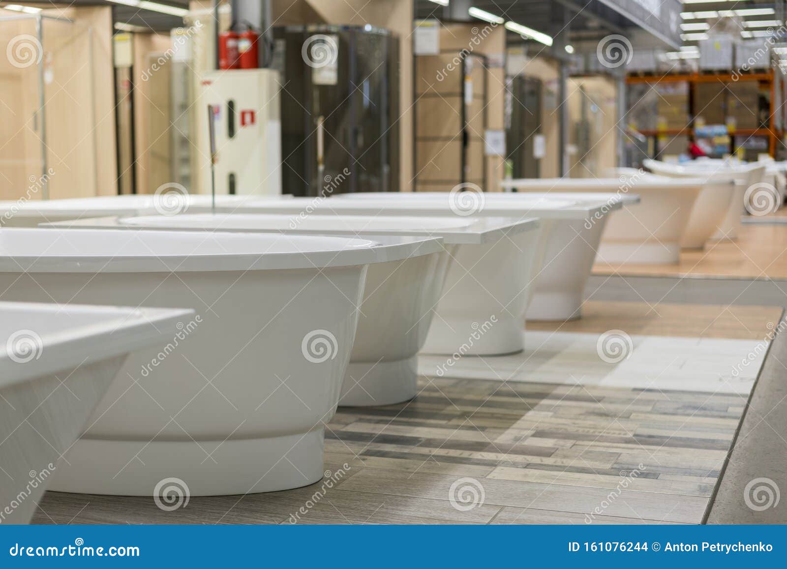 White Bathtubs in a Hardware Store. the Concept of Choosing and Installing Bathtubs Stock Photo