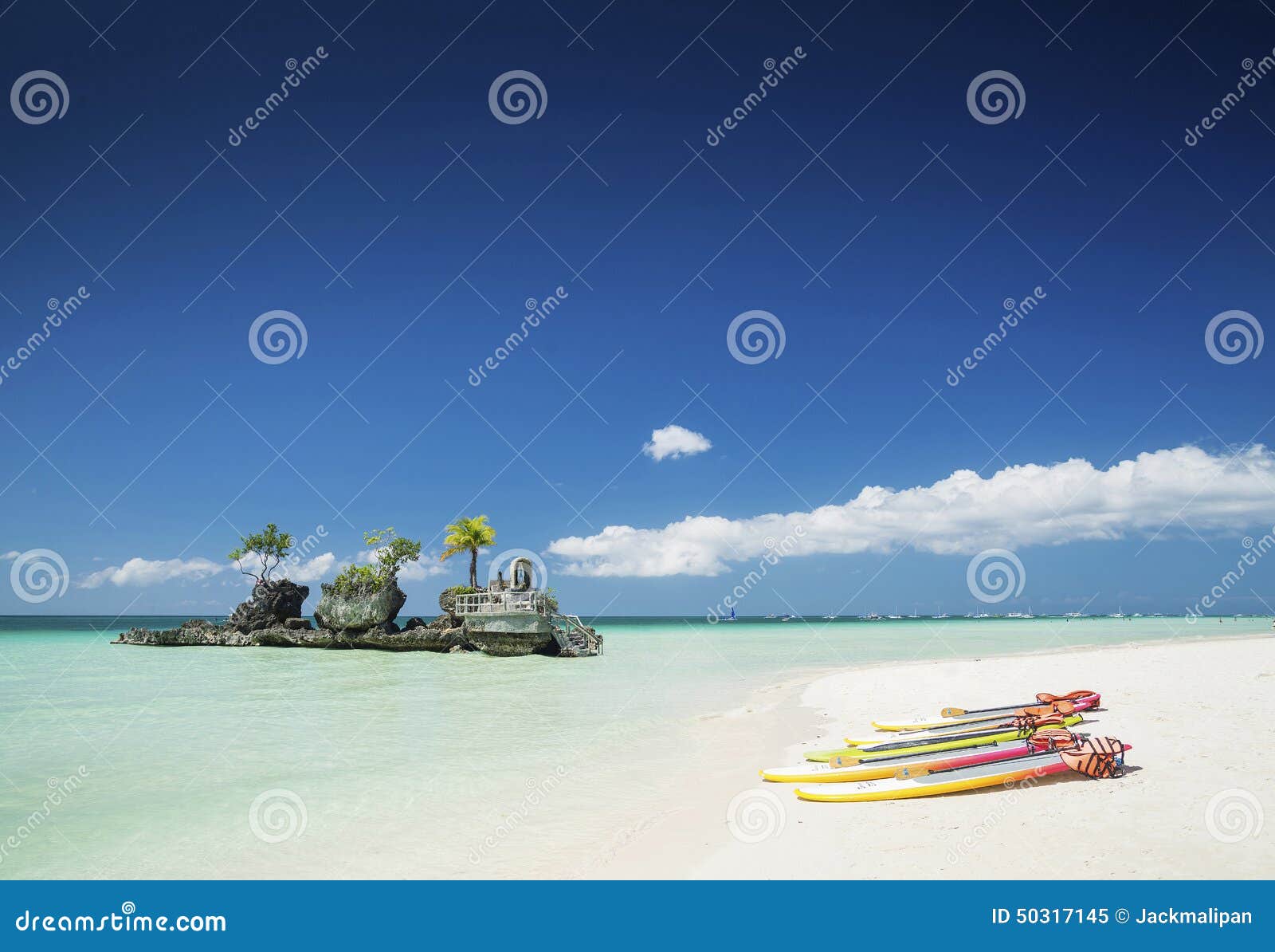 white beach and christian shrine and paddle boats on boracay tropical island in philippines