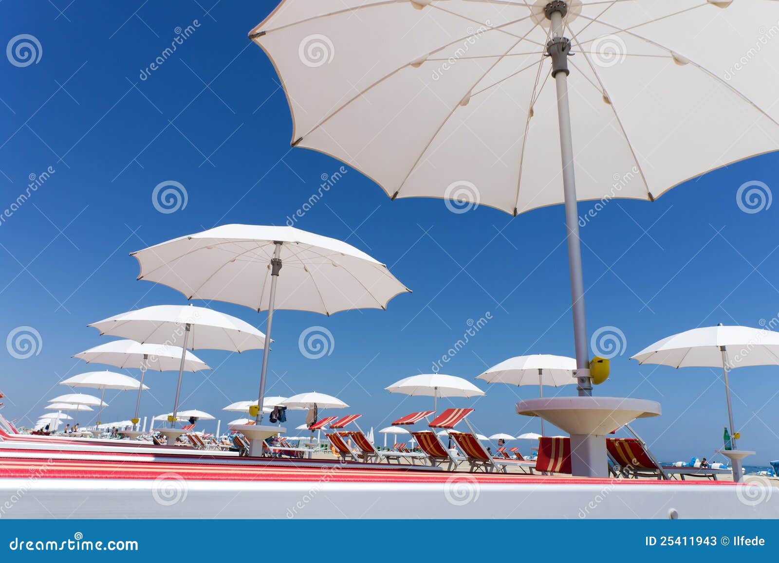 white beach umbrellas on rimini beach, italy