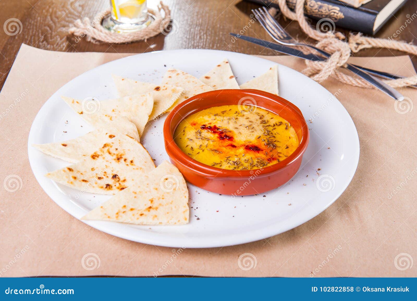 White Bean Hummus Served with Whole Grain Crackers on the White Plate