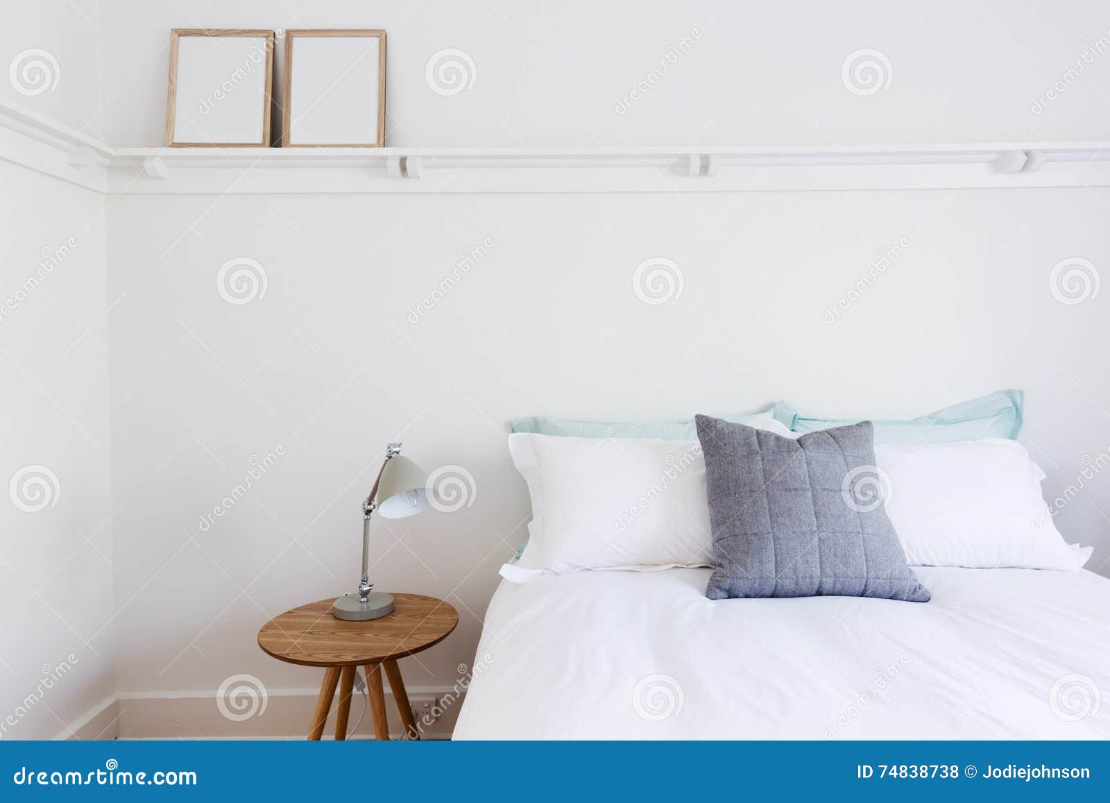 White Bedroom with Simple Decor Items in Beach Styled Home Stock Photo