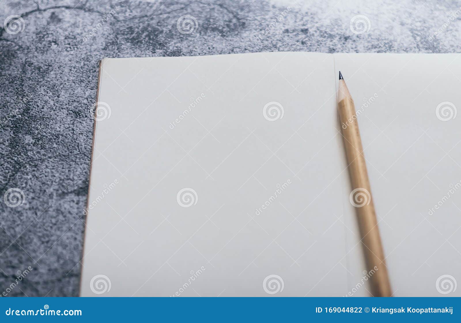 White binder blank notebook or diary or journal for writing text and  message with pencil on blue pastel wood background with copy space. Still  lifestyle photo concept. Stock Photo