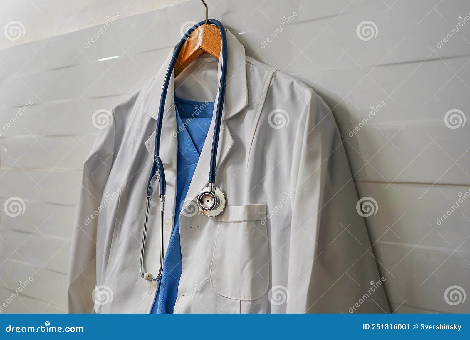 https://thumbs.dreamstime.com/z/white-blue-smock-stethoscope-wooden-hanger-ceramics-wall-background-closeup-doctor-s-scrubs-stethoscope-251816001.jpg