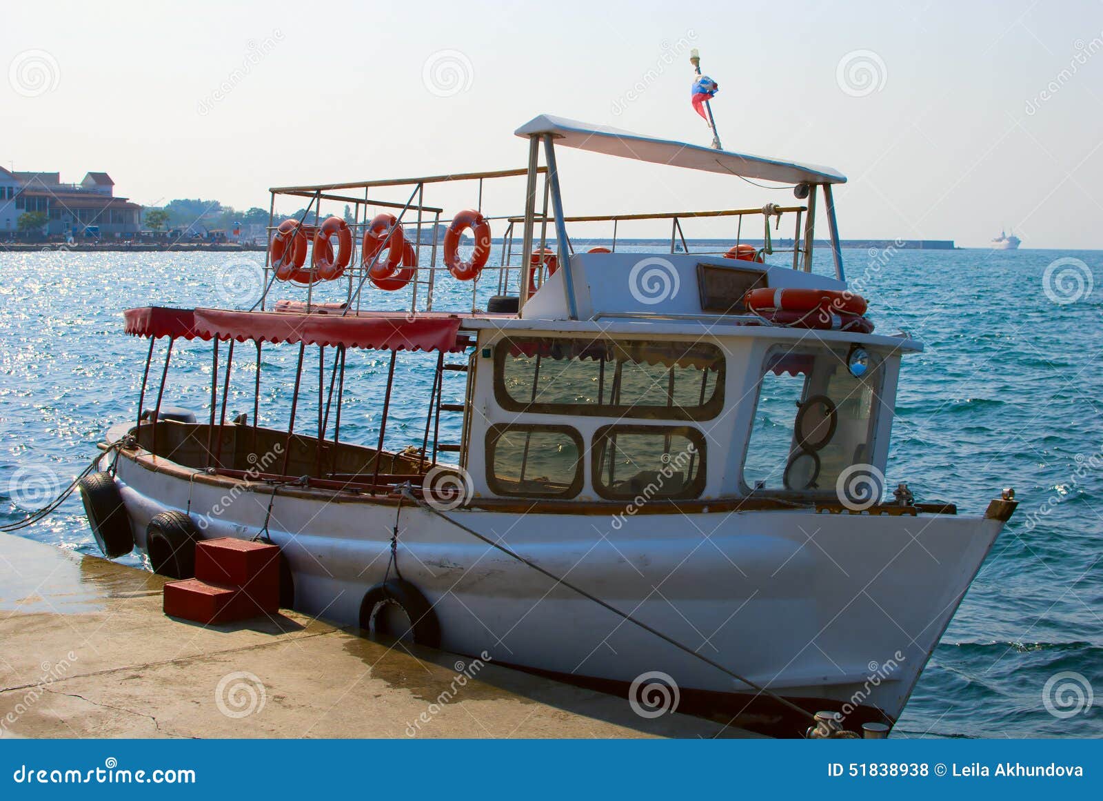 white boat morred at a pier