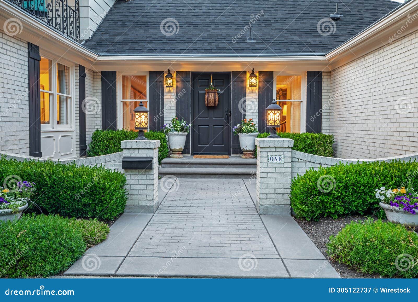 A White Brick House with a Black Door and Grey Shutters Stock Image Image of door