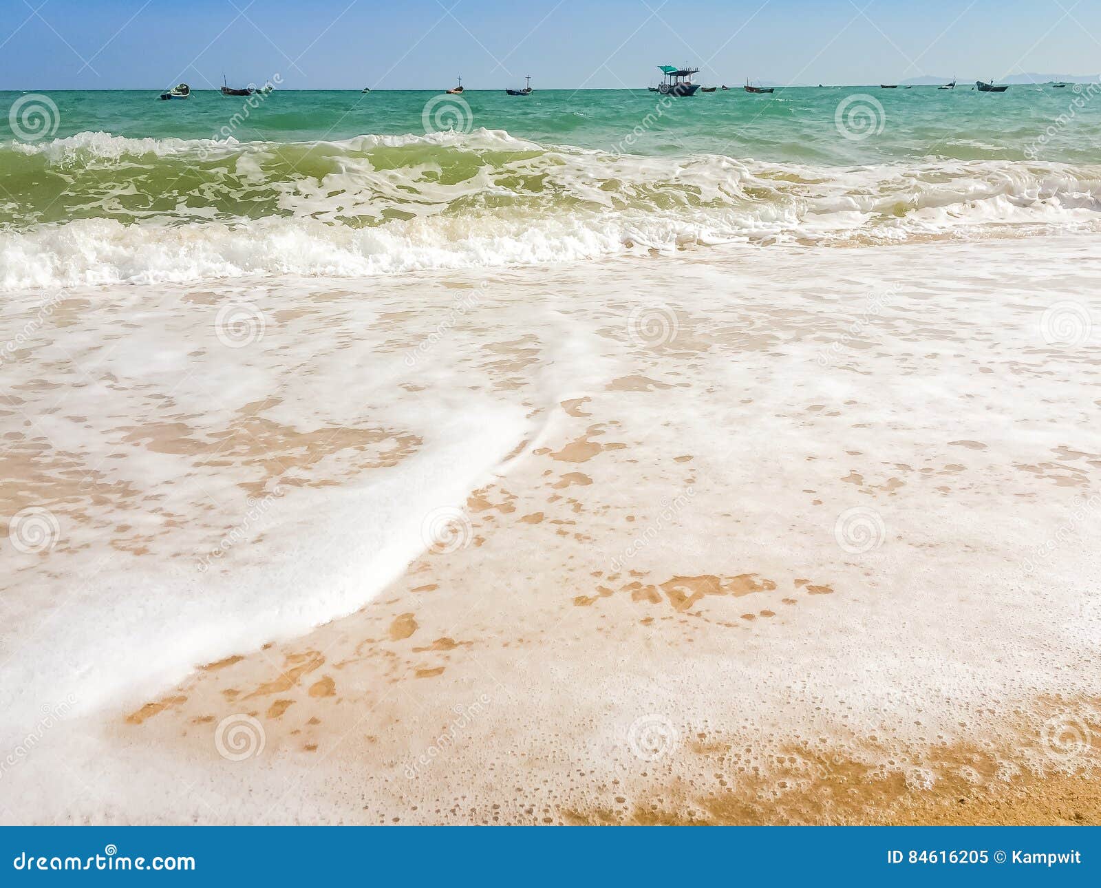 White Bubbles Created on the Beach by Ocean Waves on Seashore Foam