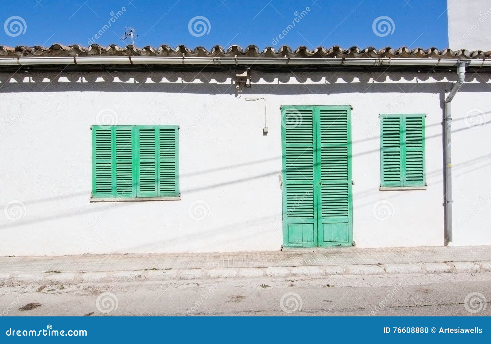 white building with green shutters in el terreno