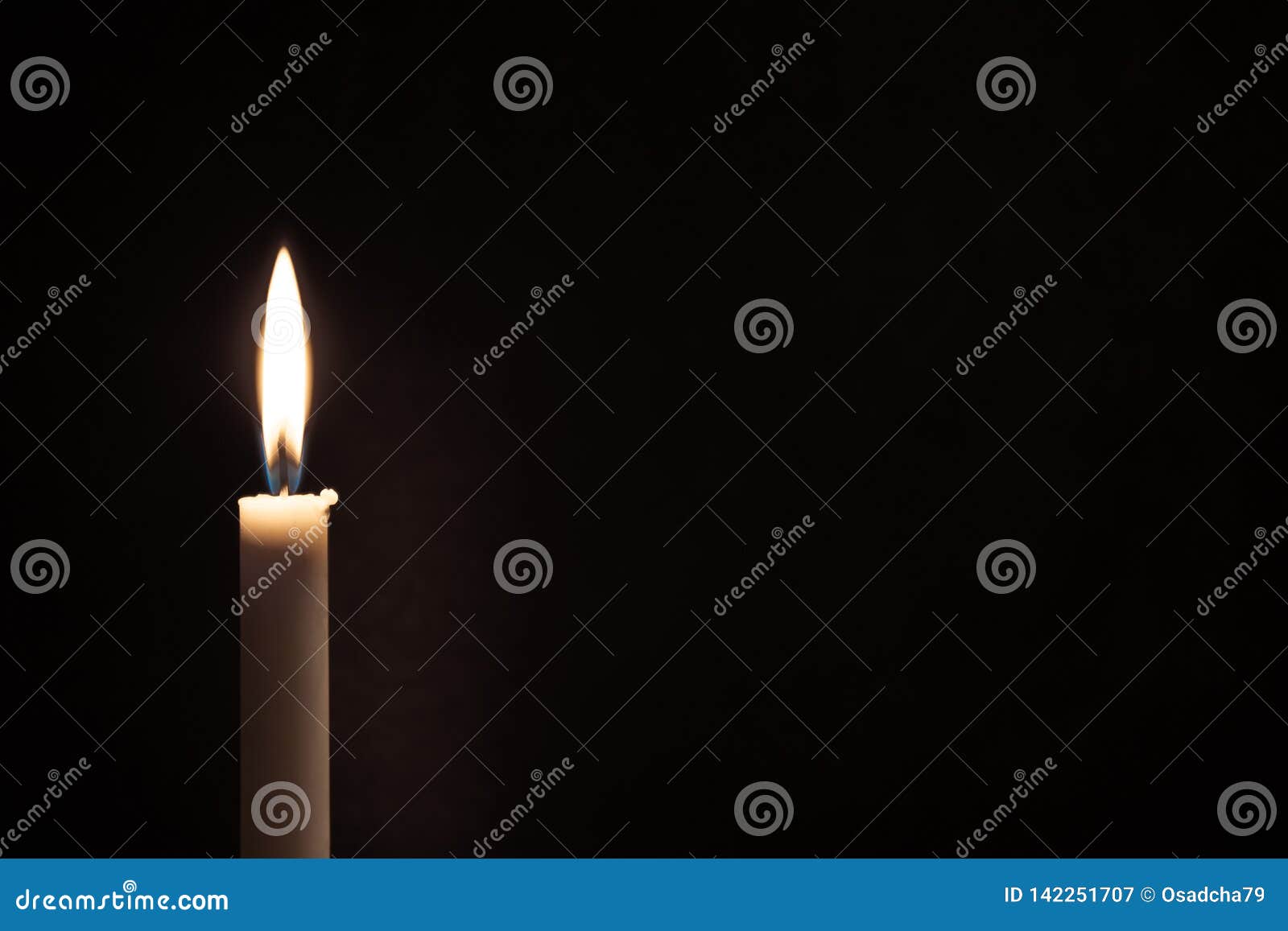 White Burning Candle on a Black Background. Mourning, Burning Candle