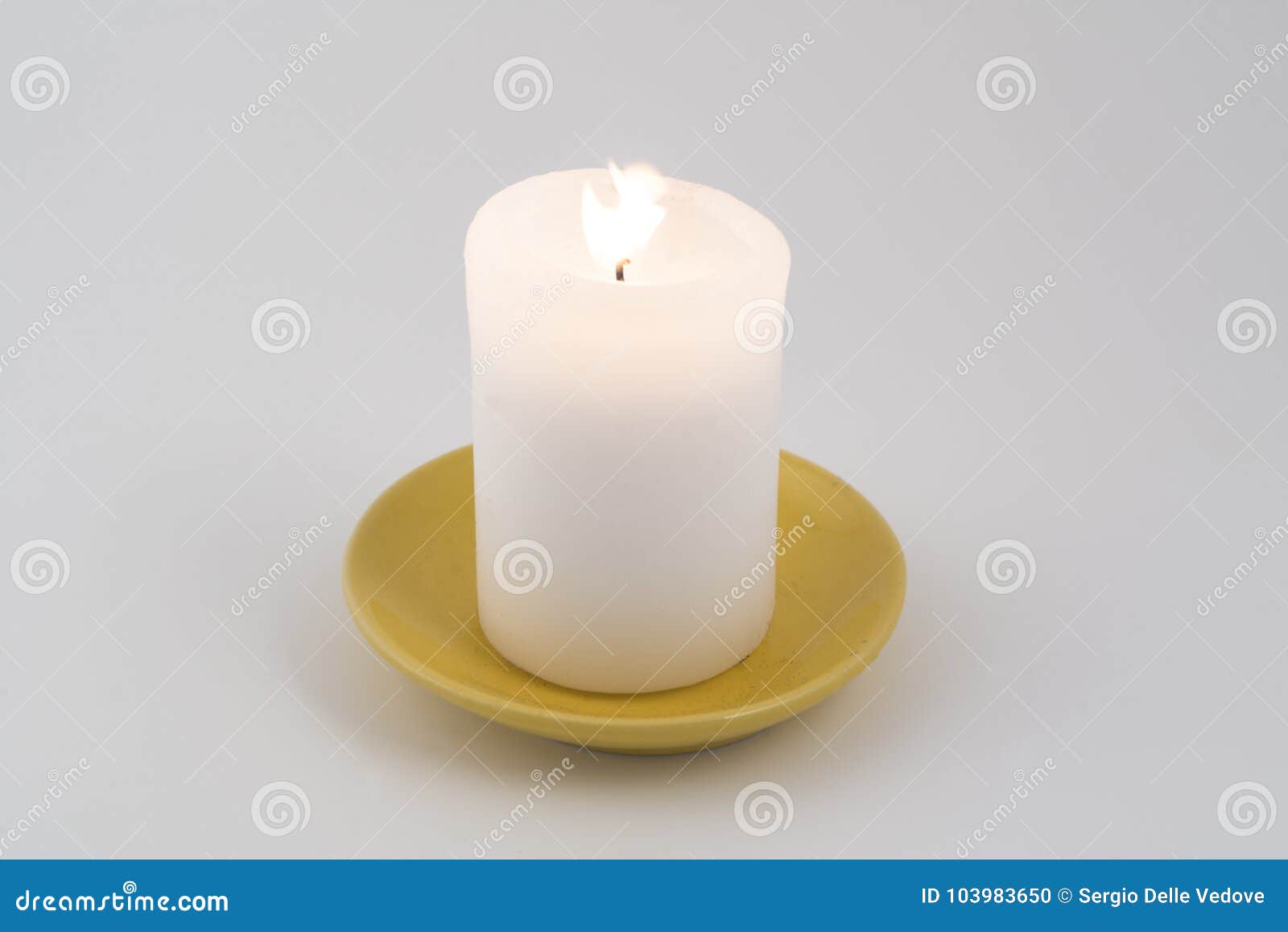 A white candle lit stock photo. Image of flame, object 103983650