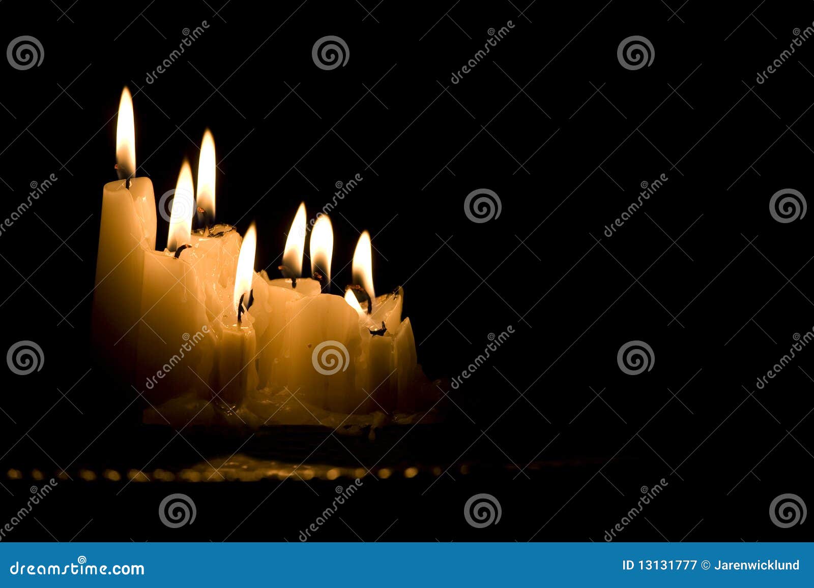 Two Candles Burning In The Dark With Double Fire And Bokeh Lights Stock