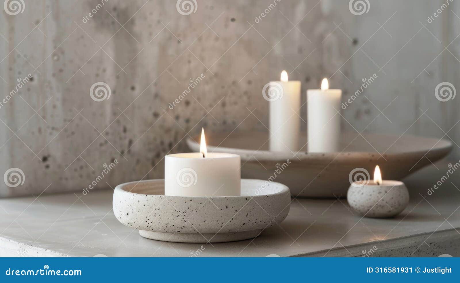 the white candles seem to amplify the raw and natural beauty of the concrete holders highlighting their unique