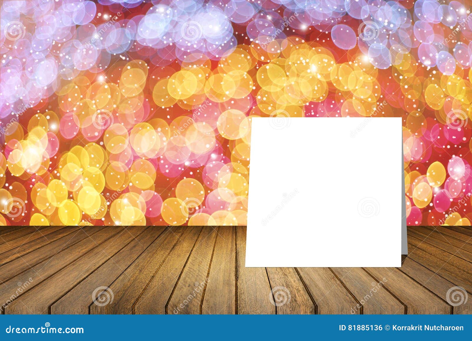 white card put on wooden desk against blurred abstract out of focus bokeh light background.use for present or mock up your product
