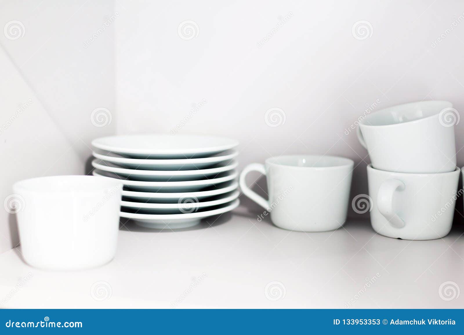 White Ceramic Coffee Cups And Saucers On Shelves Shelves With