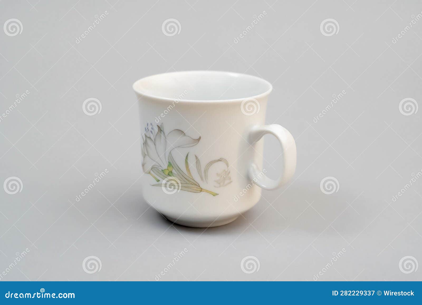 White Floral Cup Coffee Cup Tea Cup Standing on a Light Gray Background