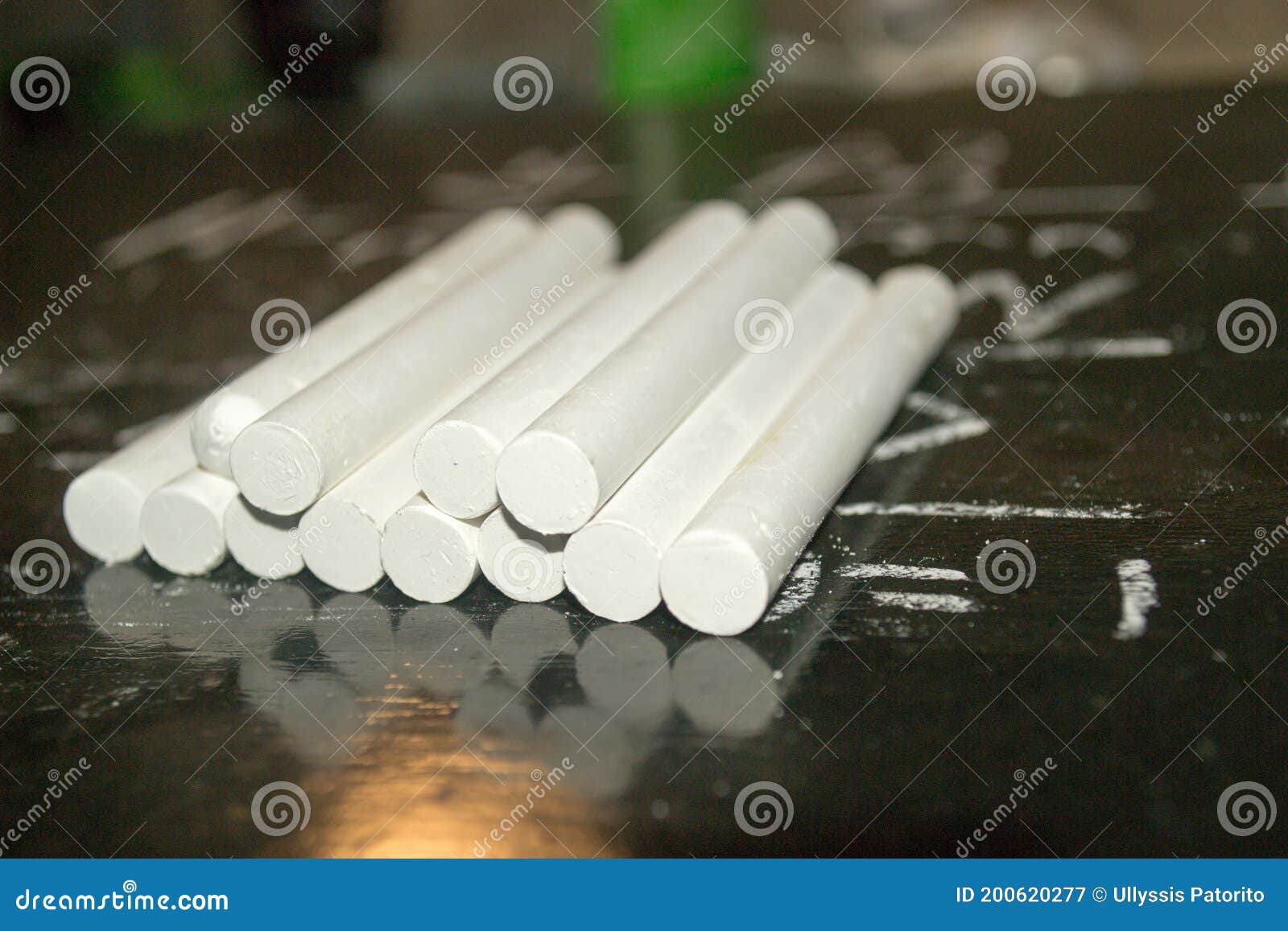 White Chalks on a Blackboard with a Written Mathematical Formula Stock