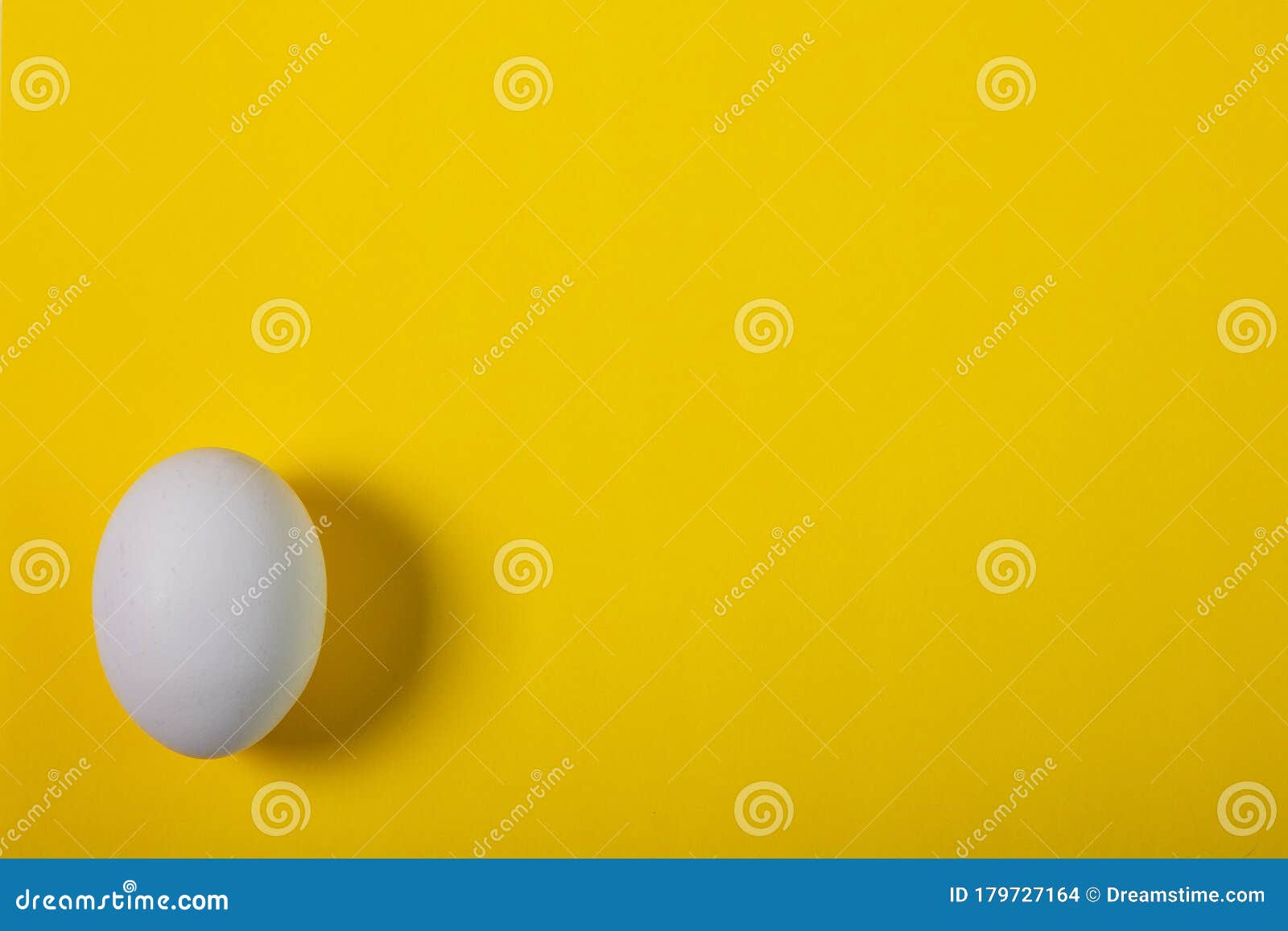 White Chicken Egg on a Yellow Background Stock Photo Image of