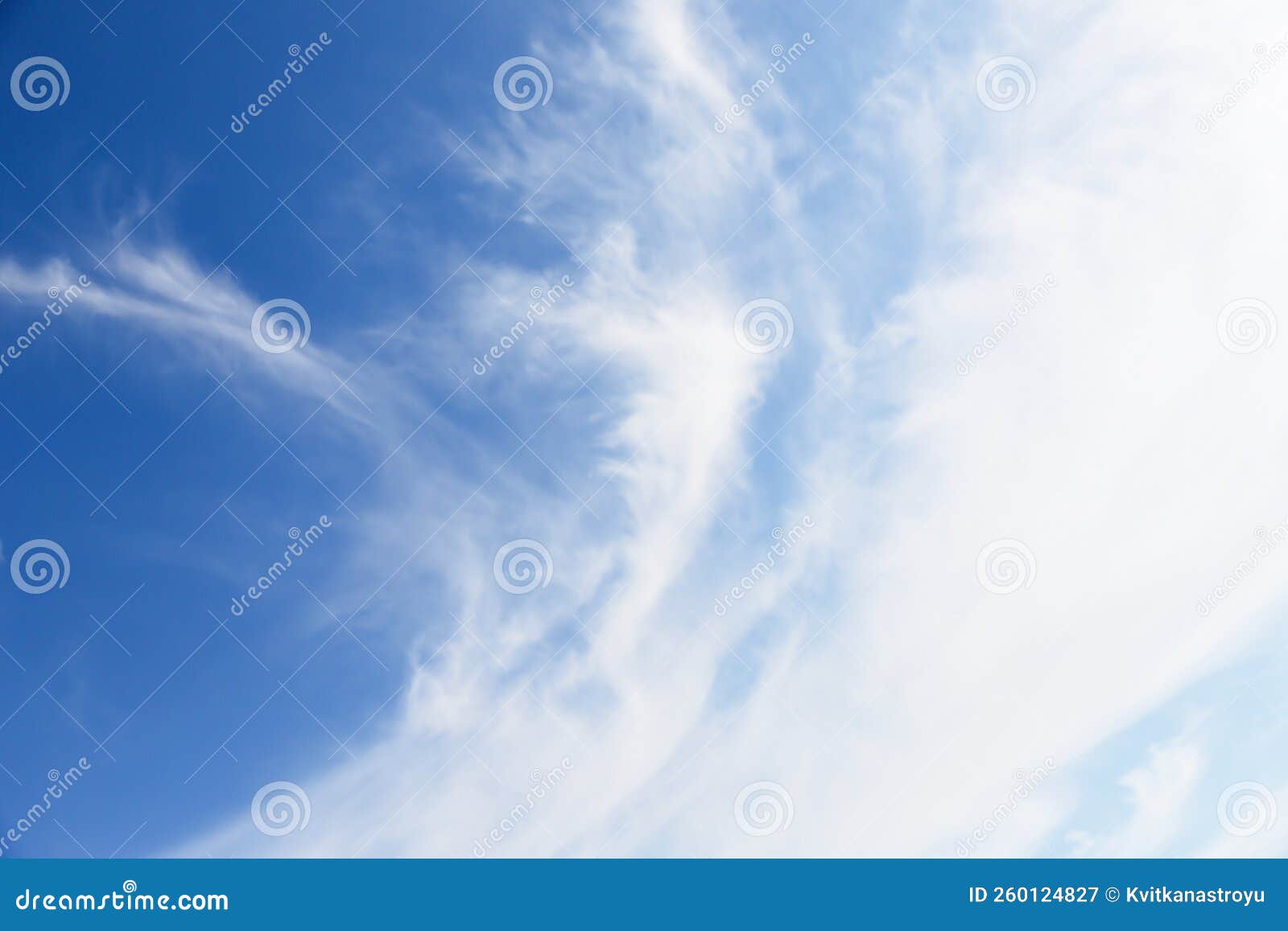 white cirro-cumulus clouds in soft blue sky