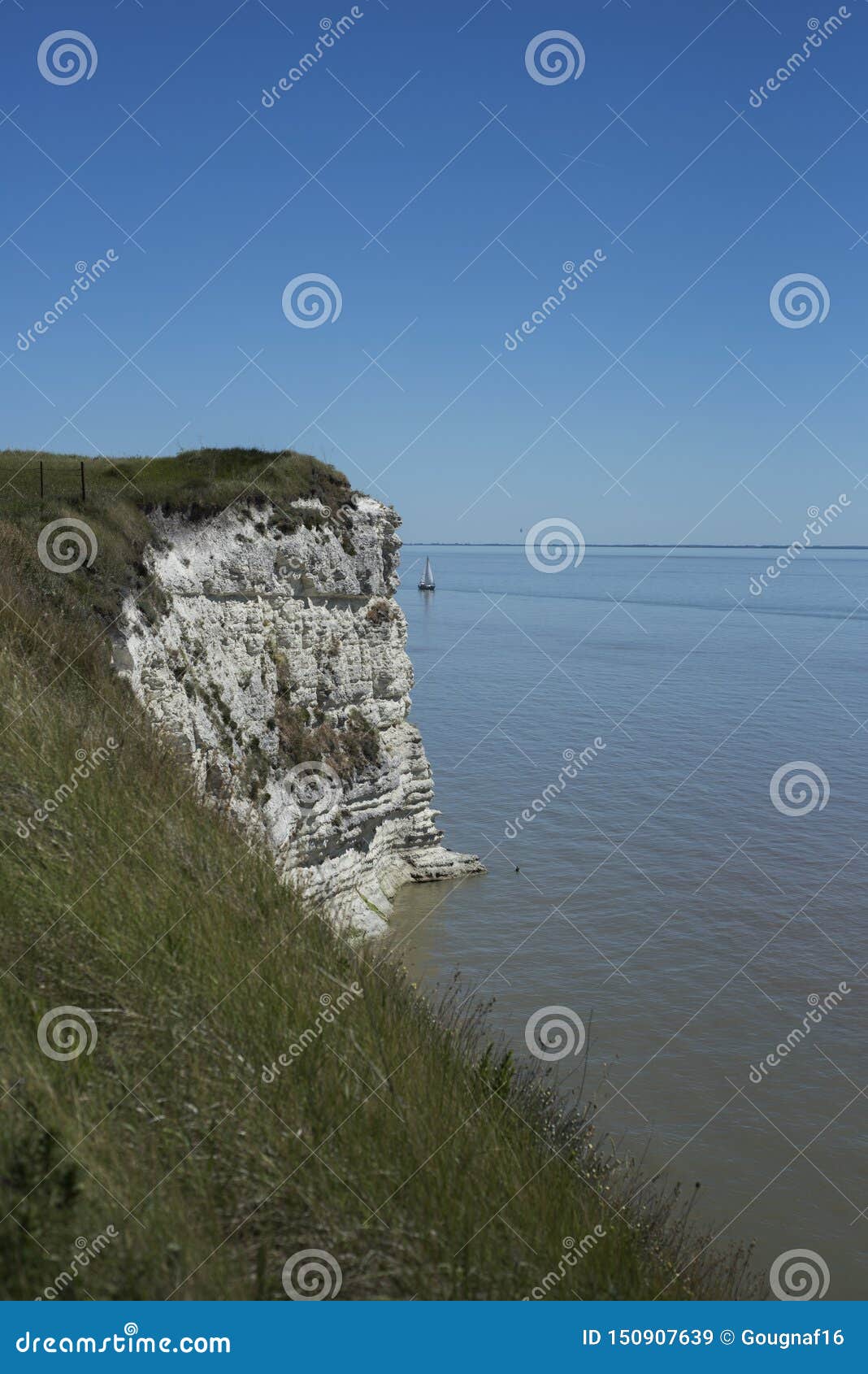 White Cliffs and a Small Sailing Boat on the French Atlantic Coast