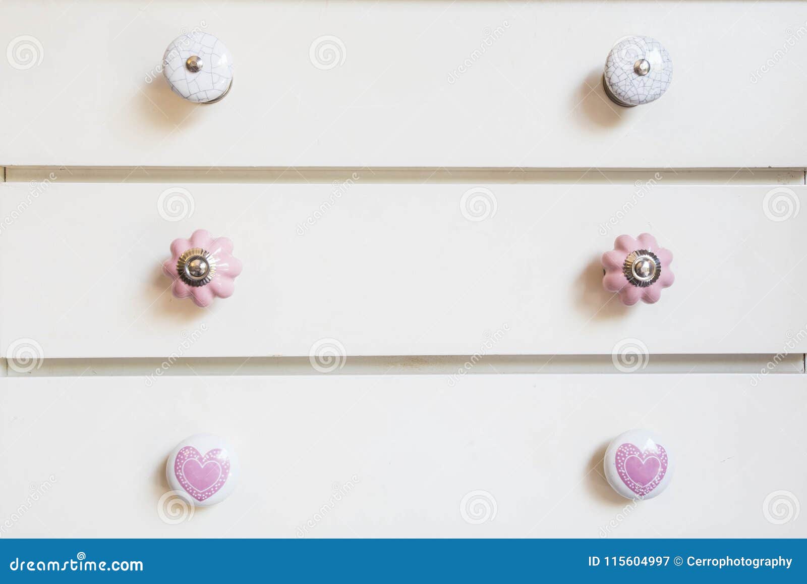 white closet doors with colorful knobs