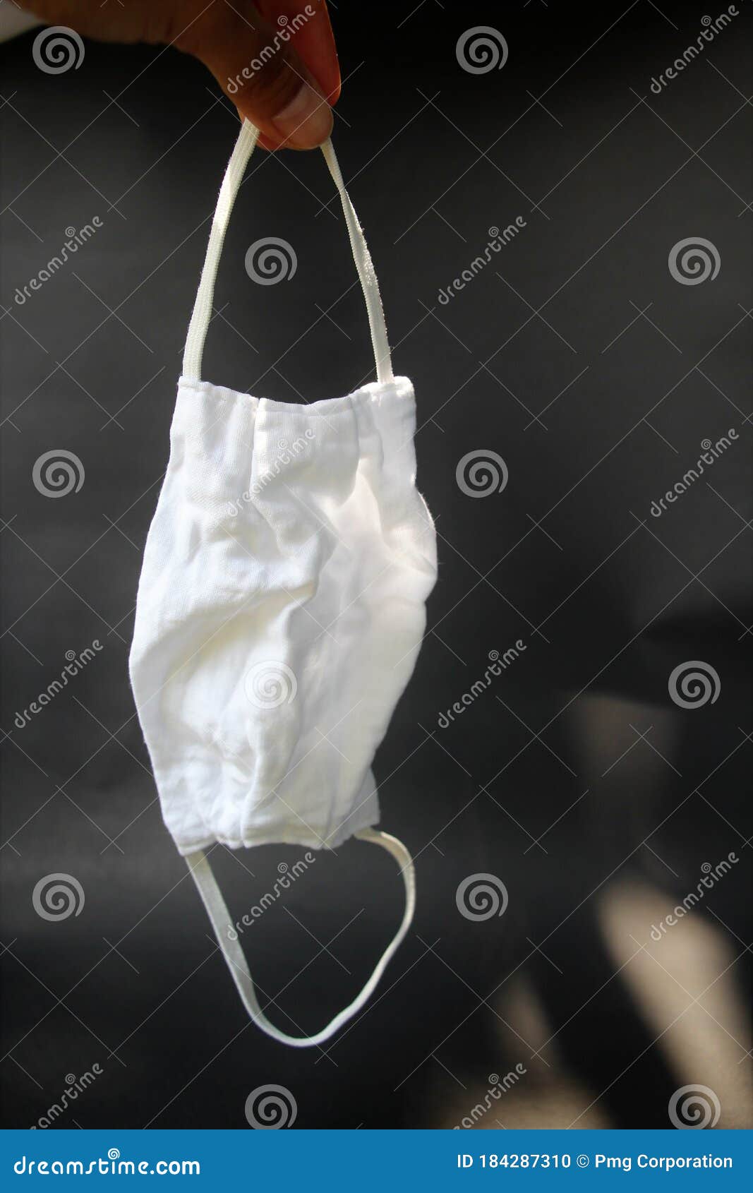 A White Cloth Mask Held in the Hand. Stock Photo Image of hand, hold 184287310