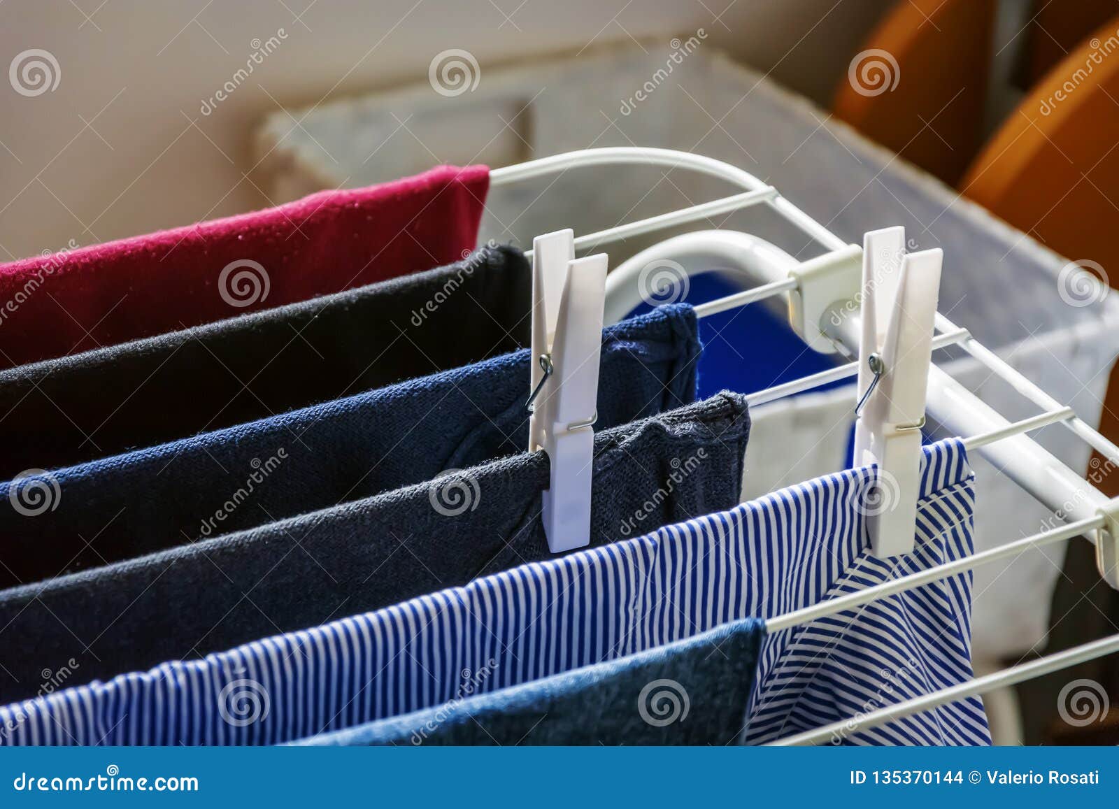 White Clothespins Hanging a Clothes Hanging on a Drying Rack Stock
