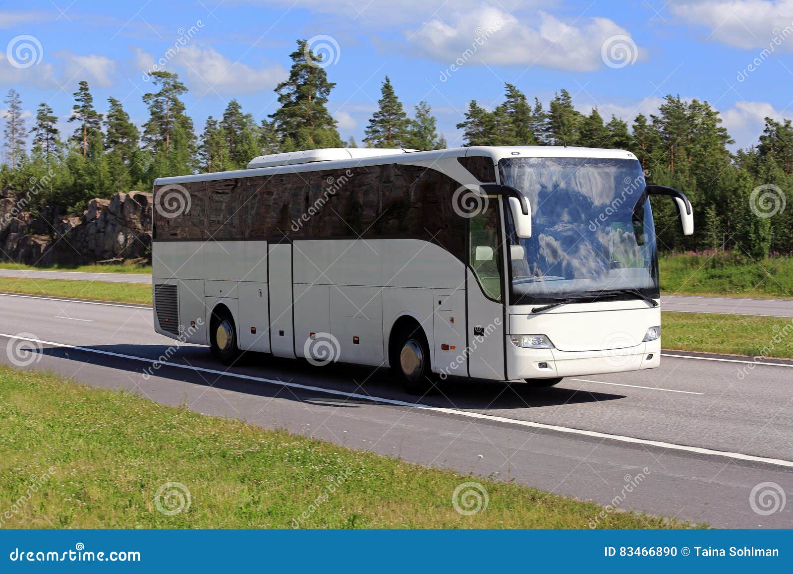 white coach bus travel along freeway at summer