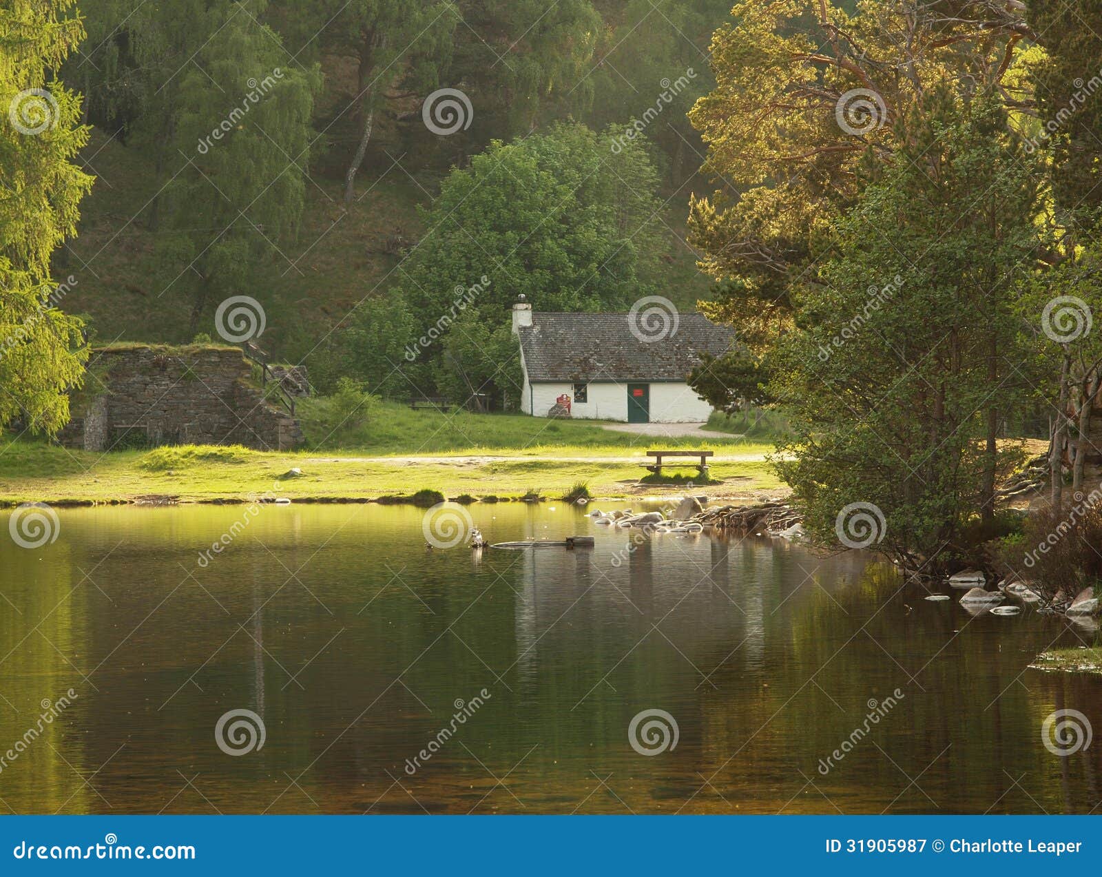 white cottage on lake, scotland