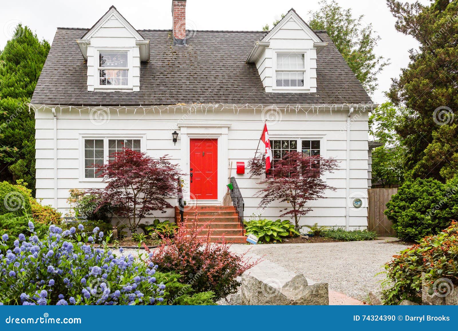 White Cottage with Red Door in Canada Stock Photo - Image of window