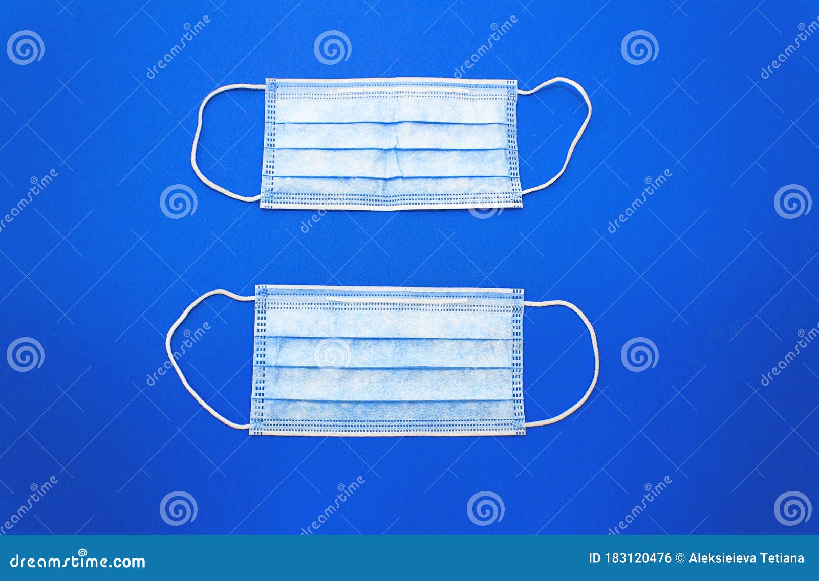 white cotton medical masks on a clasic  blue background.