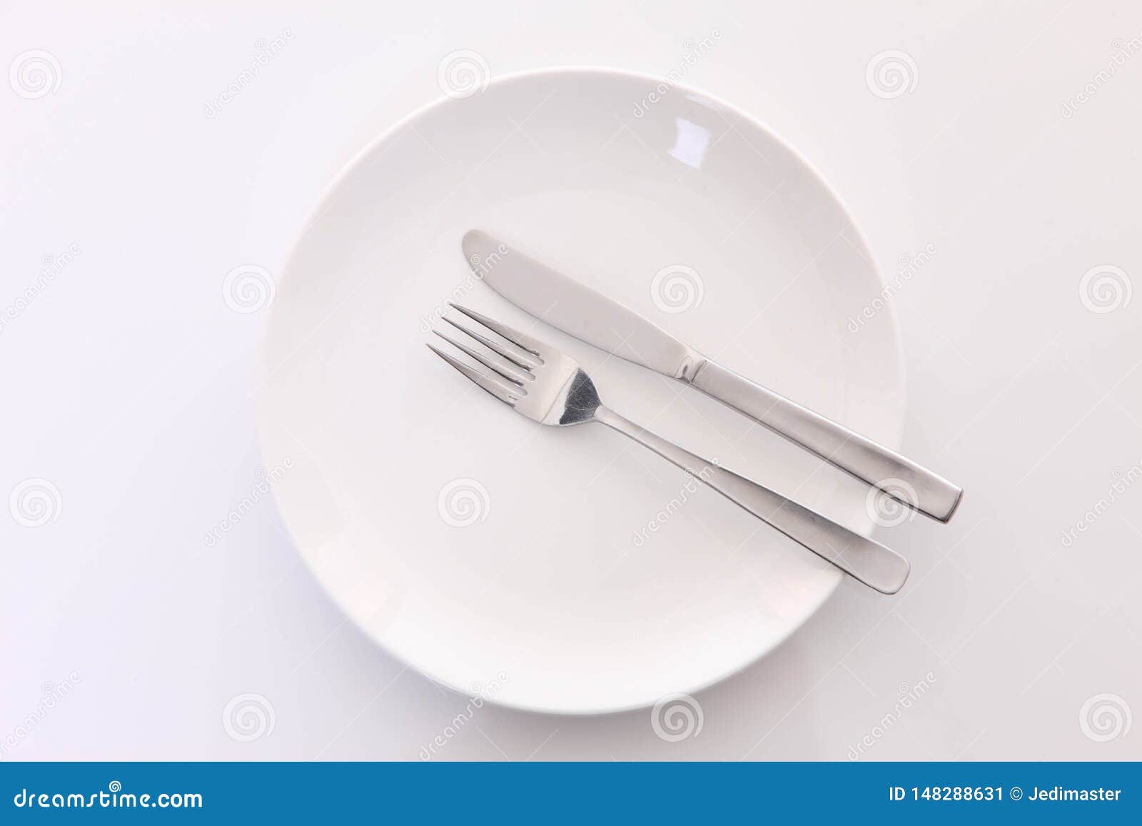 White Dish on the White Table with Cutlery Meaning FINISHED Stock Image