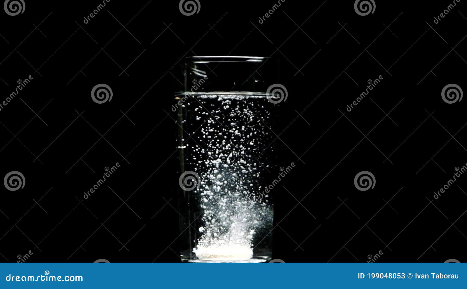 Dissolving Pill Falls into Glass of Water Dissolves Isolated on Black Backdrop Stock Video