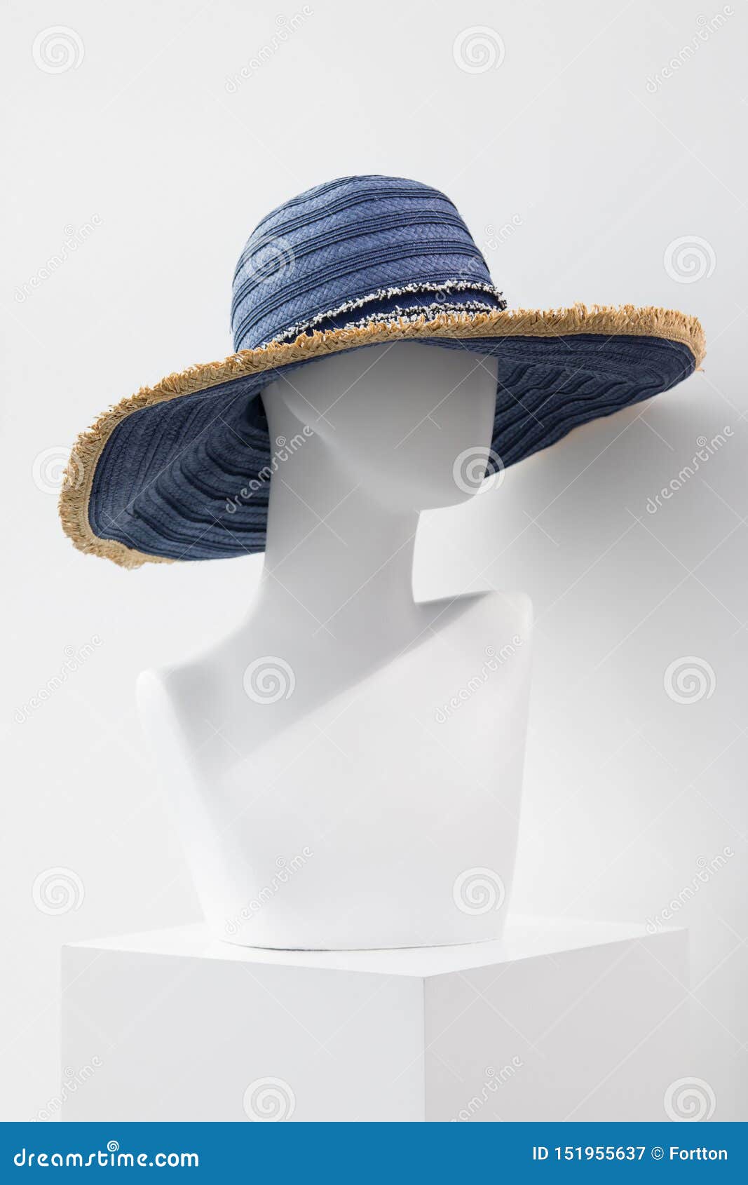 White Faceless Mannequin in a Straw Hat. Mannequin in the Store Stock