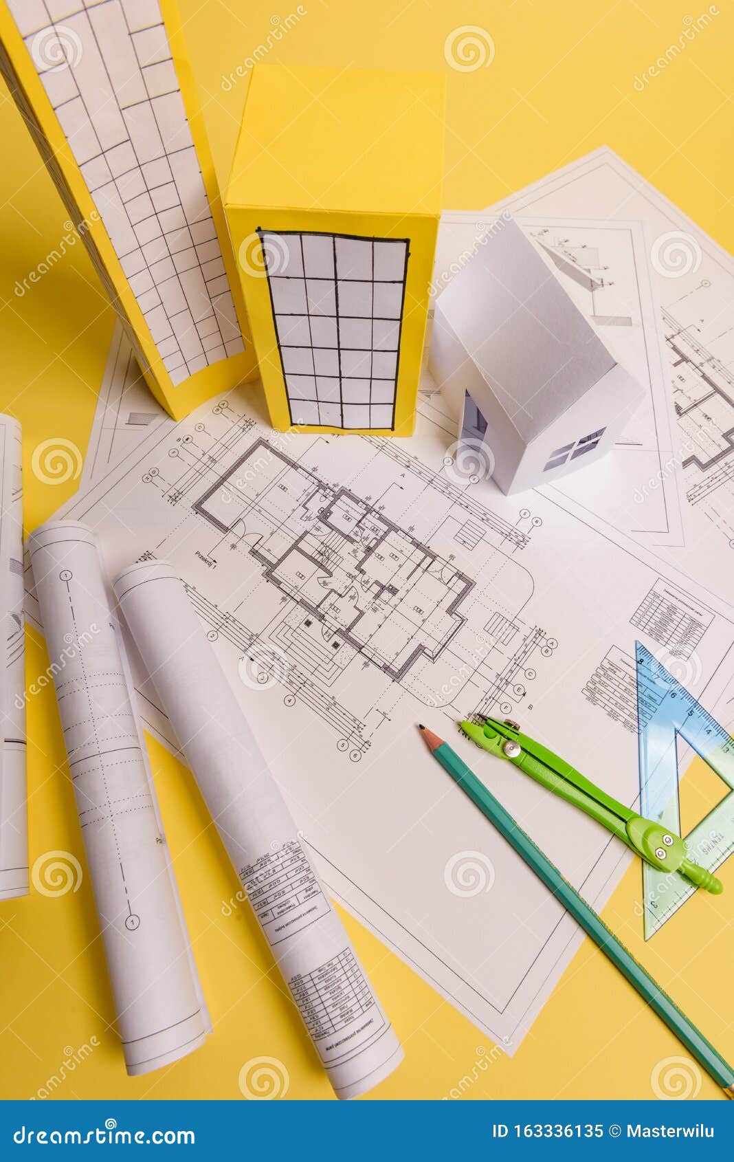 white family paper house, house projects plan and blueprints on yellow background paper. minimalistic and simple concept, style.