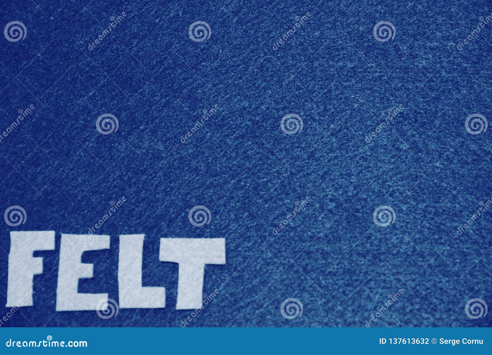 White Felt Letters On Blue Felt Background Stock Photography