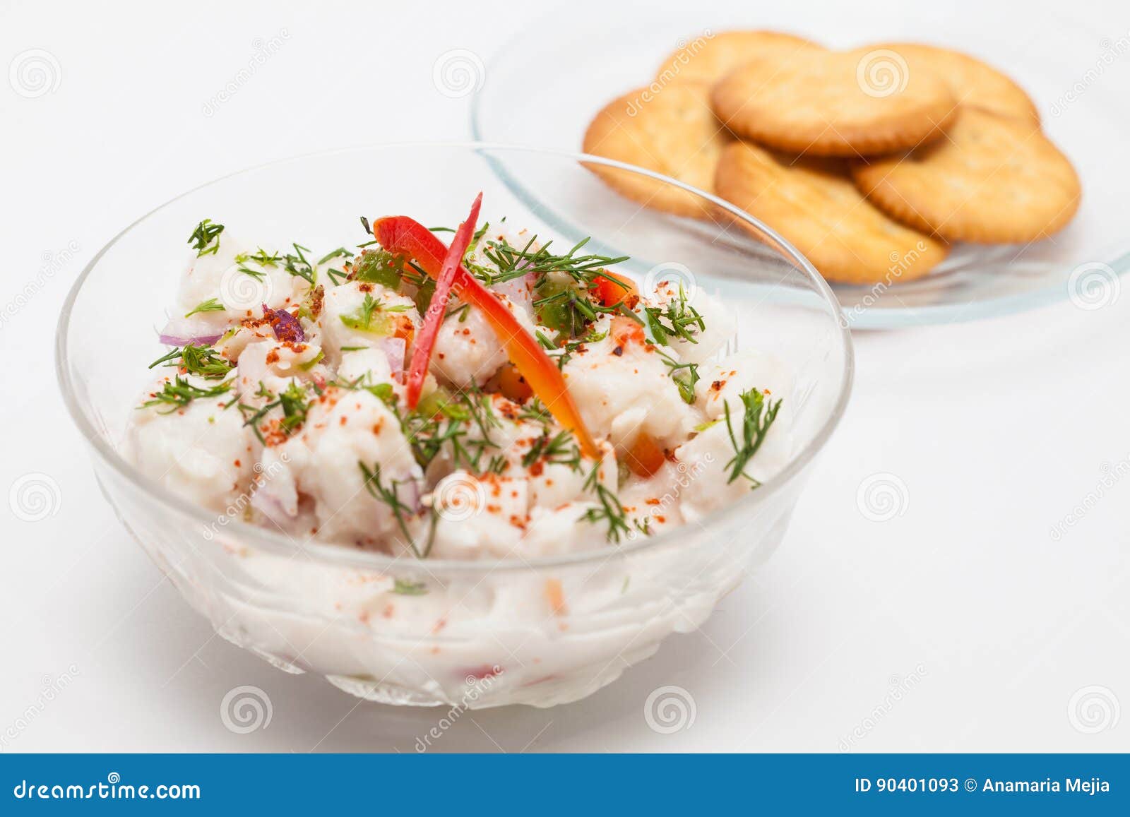White Fish Peruvian Ceviche Served in a Transparent Bowl with Crackers