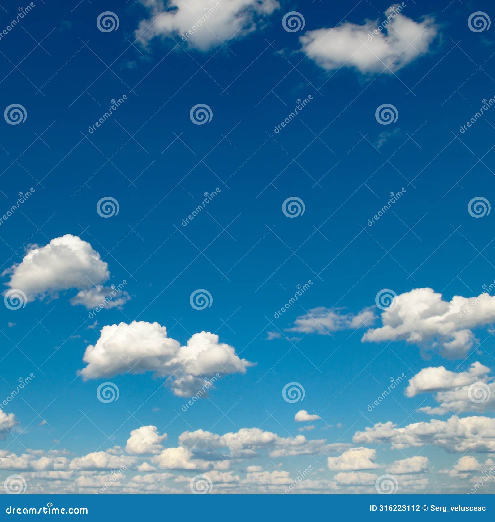 white fluffy clouds and sun on dark blue sky
