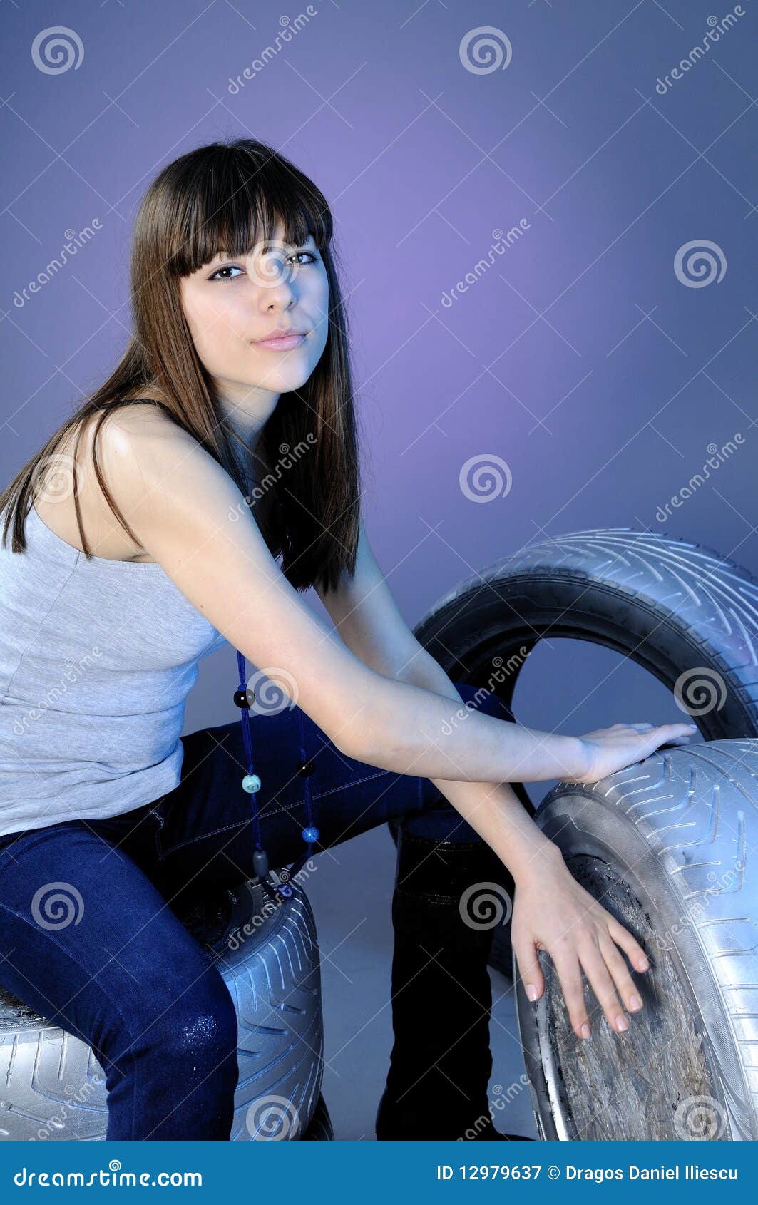 Teenager Girl Standing On Silver Tires Royalty Free Stock 